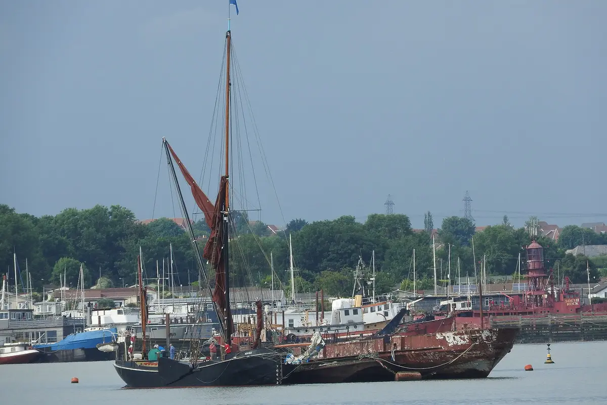 A Thames sailing barge moored among yachts at Gillingham Pier on the Medway.
