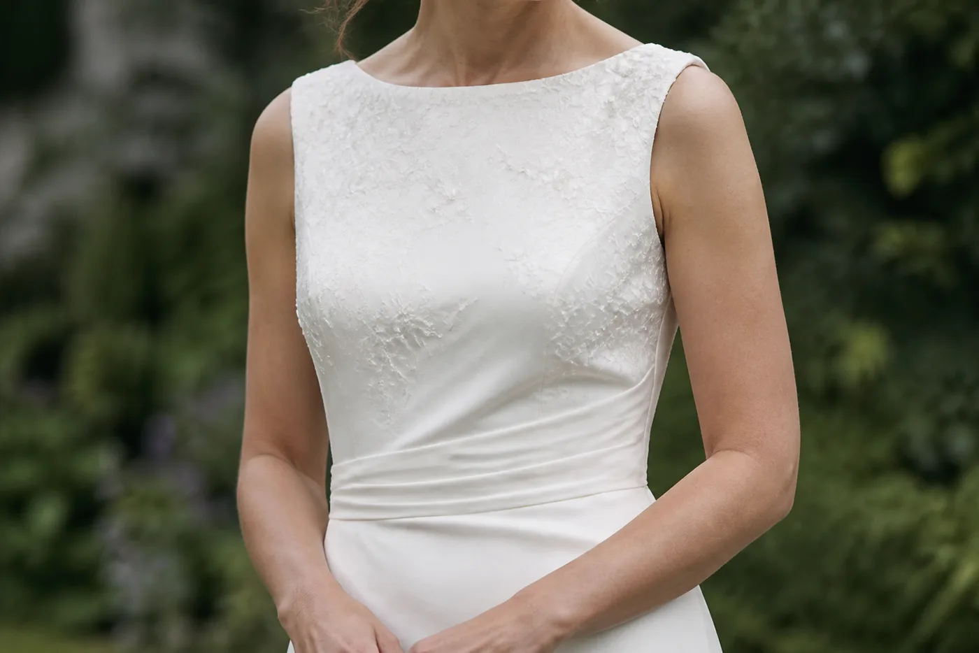 Lace and beadwork on the bodice of an ivory wedding dress